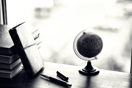 A stack of textbooks on the windowsill and writing utensilsの写真素材