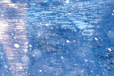 Texture of ice in winter. Pieces of frozen water on a street in the winter. The texture and texture of the frozen water in winter and outdoor.の写真素材