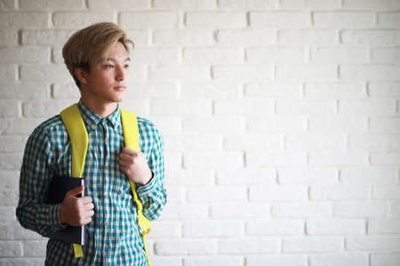 A young boy with a backpack studentの写真素材