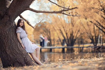 Young girl on a walk in the autumnの写真素材