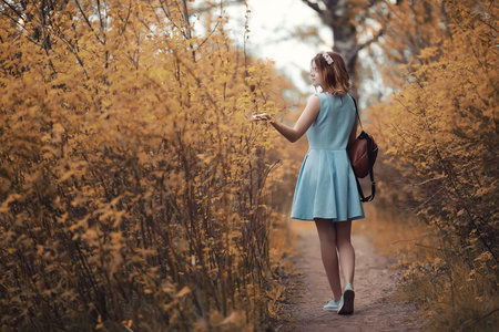 Young girl on a walk in the autumn