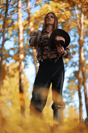 Man with guitar in autumn day