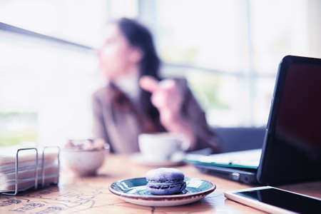 Girl eating coffee cakesの写真素材