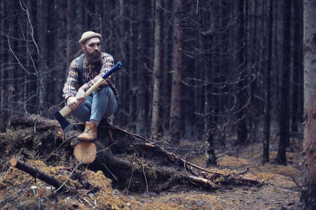 Autumn rainy weather and a young man with an umbrellaの写真素材