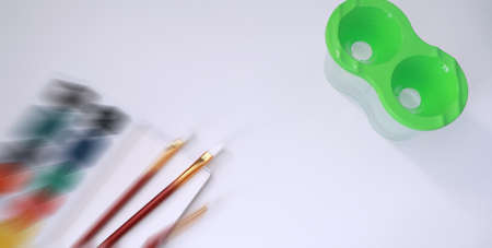 Drawing paints on a white sheet of paperの写真素材