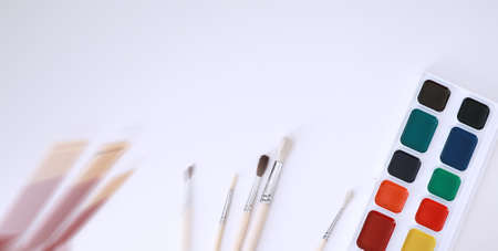 Drawing paints on a white sheet of paperの写真素材