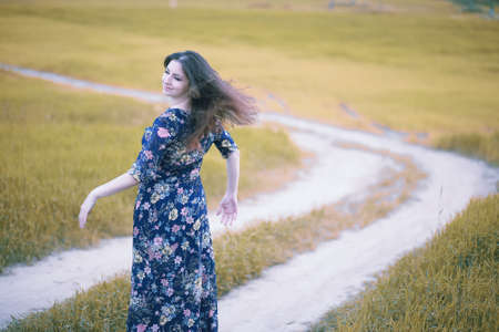 Pregnant girl in a dress in natureの写真素材