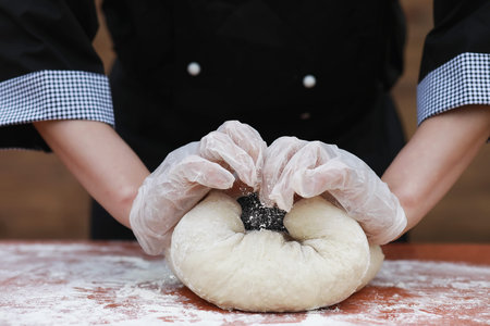 the cook makes flour out of flour for baking on the table