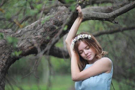 Girl in blue dress in green parkの写真素材