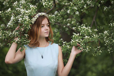 Girl in blue dress in green parkの写真素材