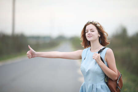 Girl in blue dress in green parkの写真素材