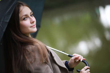 Young girl in a coat in a spring parkの写真素材