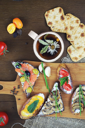 Assorted sandwiches with different fillings, fish mushrooms and vegetables