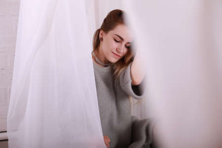 Girl with blond hair and gray sweaterの写真素材