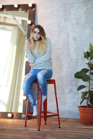 A young girl rests in a cozy roomの写真素材