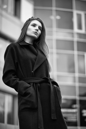 Girl in a coat black and white photoの写真素材