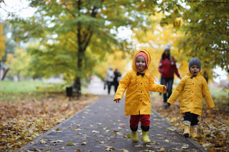 A child in a raincoat for a walk outsideの写真素材