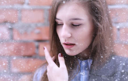 Young girl outdoors in winter. Model girl posing outdoorsの写真素材