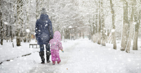 Winter park under the snow. Snowstorm in the city park. Park for walks with the whole family under the snow cover.の写真素材