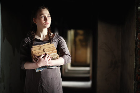A girl with old books in the old house