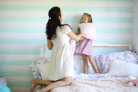 Little girl is playing with a big red cat in the country in Russia. Image with selective focusの写真素材