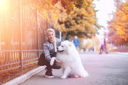 Lovely girl on a walk with a beautiful dogの写真素材