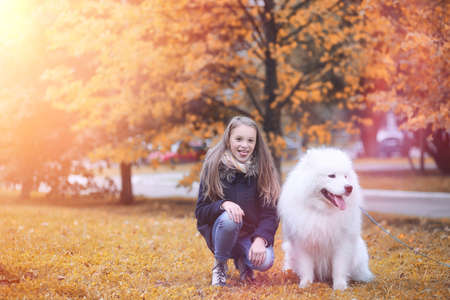 Lovely girl on a walk with a beautiful dogの写真素材