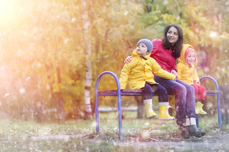 A child in a raincoat for a walk outside in autumnの写真素材