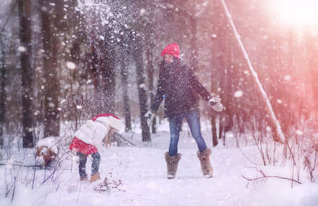 A young mother and her daughter having fun in snowの写真素材