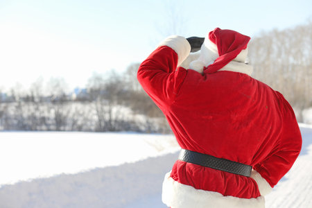 Santa Claus comes with gifts from the outside. Santa in a red su