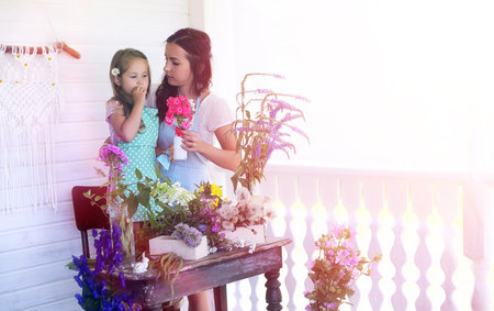 A young girl with a daughter is picking up a bouquet.の写真素材