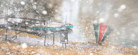 Winter park lonely bench under the snowの写真素材