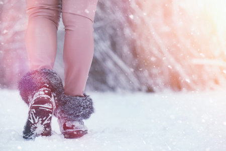 Young family with children are walking in the winter park. Winter walk of parents with children....