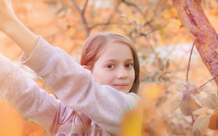 A girl on a walk in a park. Young red-haired girl in the springの写真素材