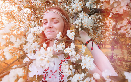 A girl on a walk in a park. Young red-haired girl in the spring