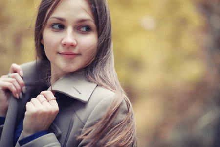 Young girl in a coat in autumn  park