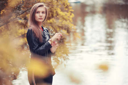 Young girl in autumn parkの写真素材