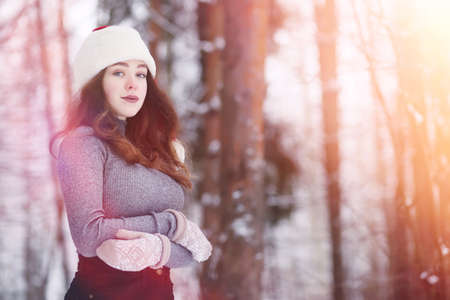 A young girl in a winter park on a walk. Christmas holidays in tの写真素材