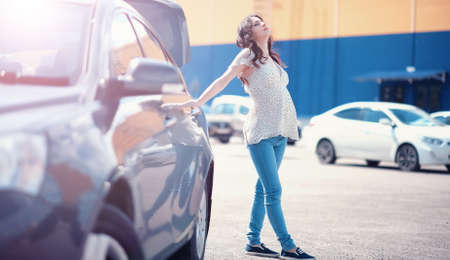 Girl with food coming out of the grocery storeの写真素材
