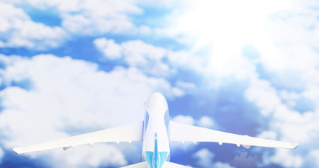 The travel by plane flies in the sky above the clouds.