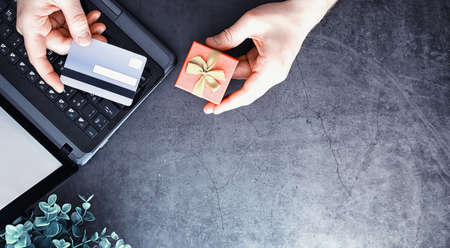 Shopping concept. Supermarket trolley, money and gifts on the background.の写真素材