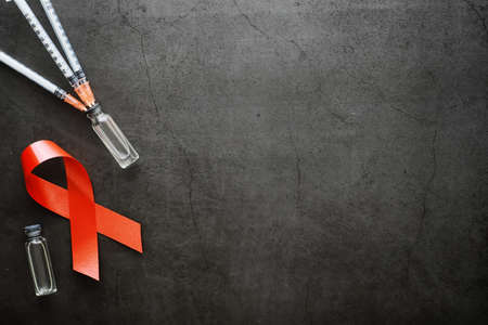 Symbol of human immunodeficiency virus disease. Red ribbon. A helping hand and support. Background.の写真素材