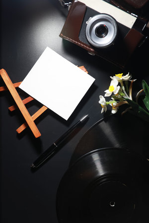 Vinyl plate and retro camera on the table.