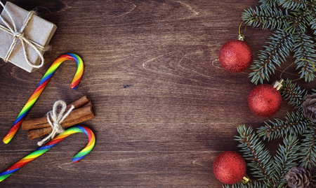 New Year's background. Spruce branches on a wooden table. Ornaments for the New Year tree. Christmas...