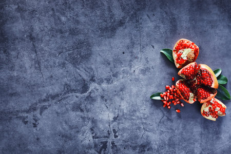 Ripe red pomegranate. Ripe grains of pomegranate on the table. Pomegranate juice.