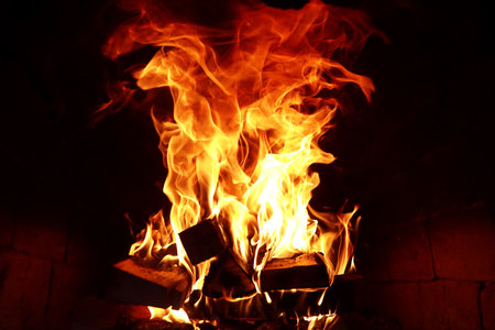 Long tongues of flame of burning fire in a brick ovenの写真素材