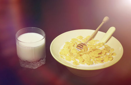 Corn flakes in a plate. Breakfast from flakes with honey and milk. Fast breakfast with corn flakes