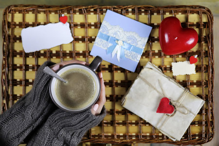 girl drinking coffee looking at the card Valentine's Dayの写真素材