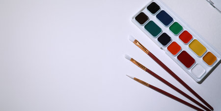 Stationery for drawing paints on a white sheet of paperの写真素材
