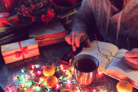 a man with a blank book in his hands for the New Year's table with decorationsの写真素材